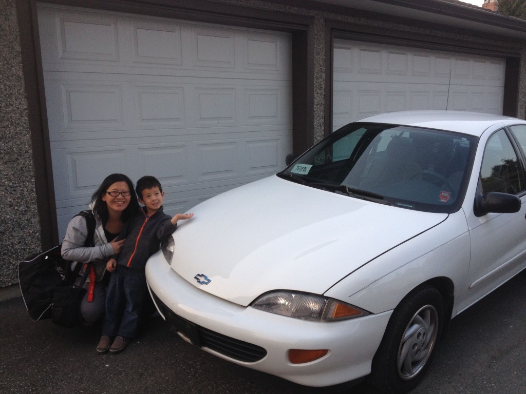 My wife Wendy and son Noah with the 1995 Chevrolet Cavalier, soon to be headed to the Scrap-It yard